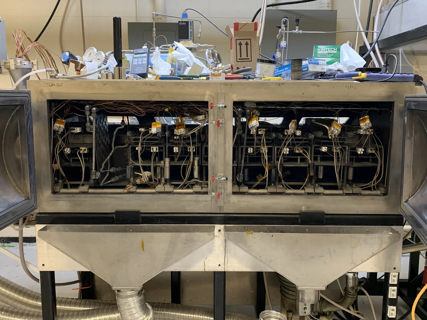 Vacuum deposition system opened for maintenance and decontamination
