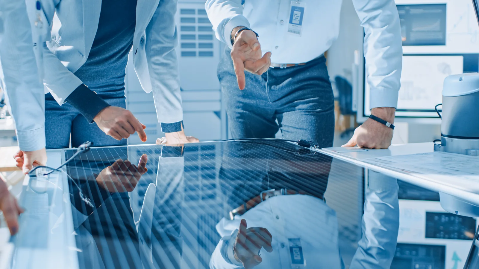 Engineers examining a thin-film panel